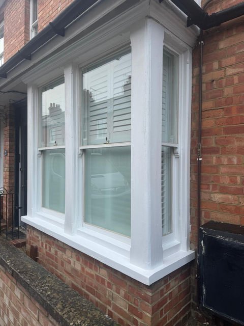 Bay window installation with brick exterior.