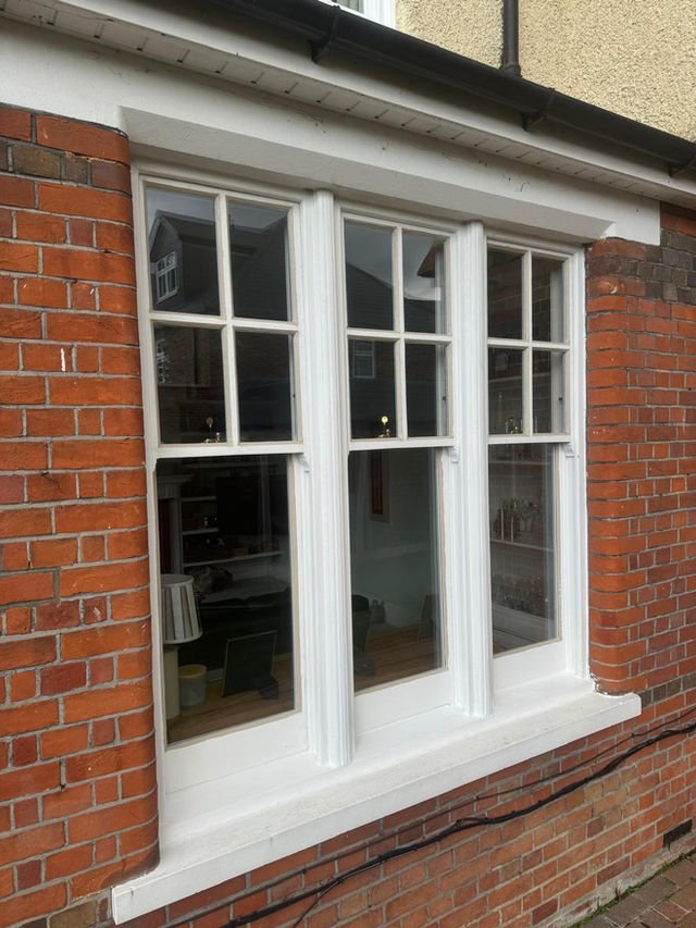 Sash window installation with brick exterior.