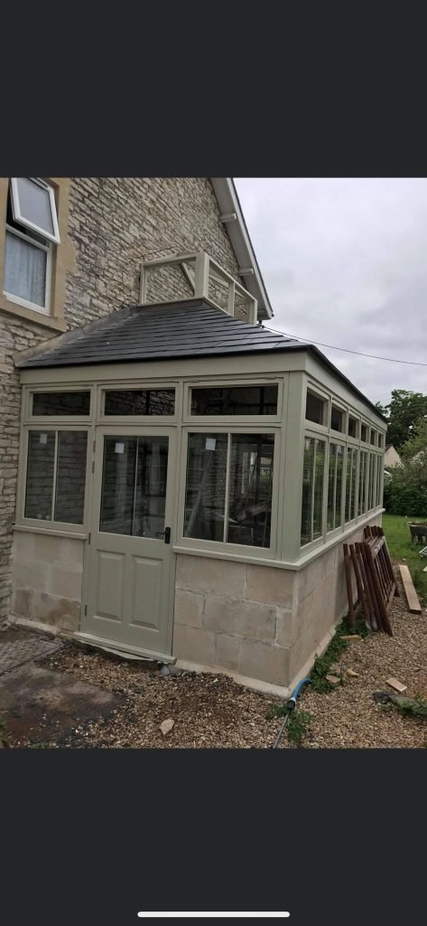 Conservatory with timber windows and door, likely a recent installation.