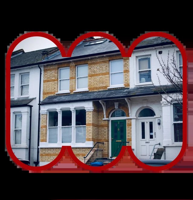 Row of houses, possibly showing a building restoration project. Framed in red.
