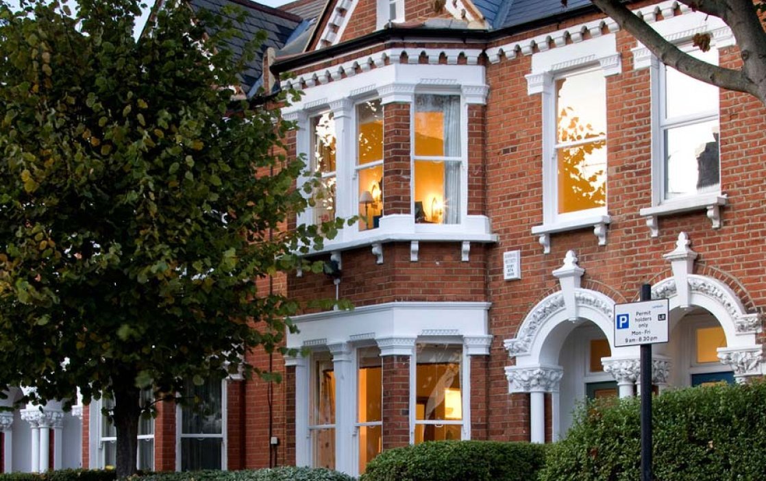 Exterior view of a period building with multiple sash windows, demonstrating the scale of projects.