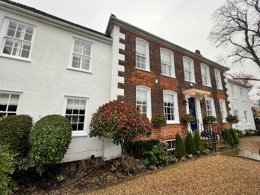 Large period home with visible sash windows, showcasing potential projects.