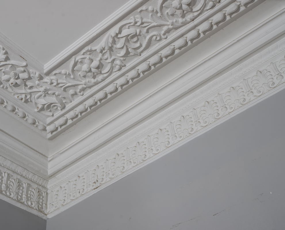 Detailed cornice and coving work, showcasing plastering skills.
