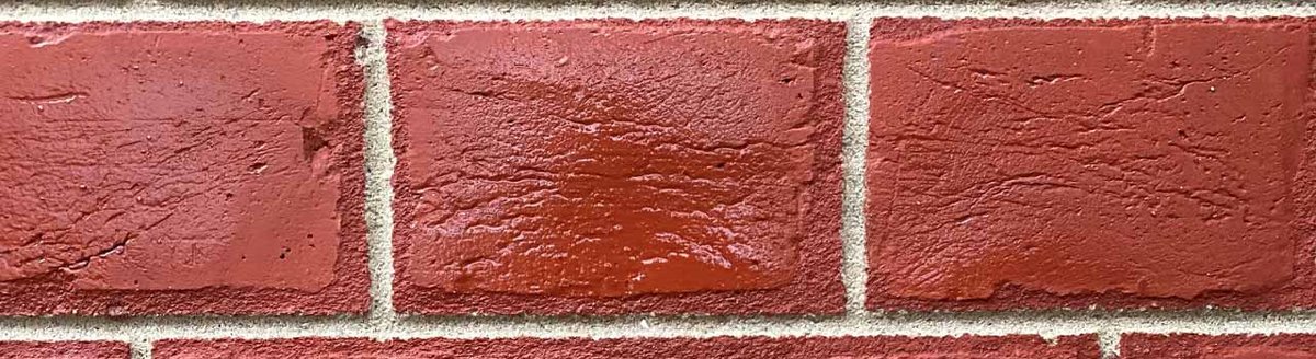 Close-up of red brickwork with clean repointing, showcasing brick cleaning and repointing skills.