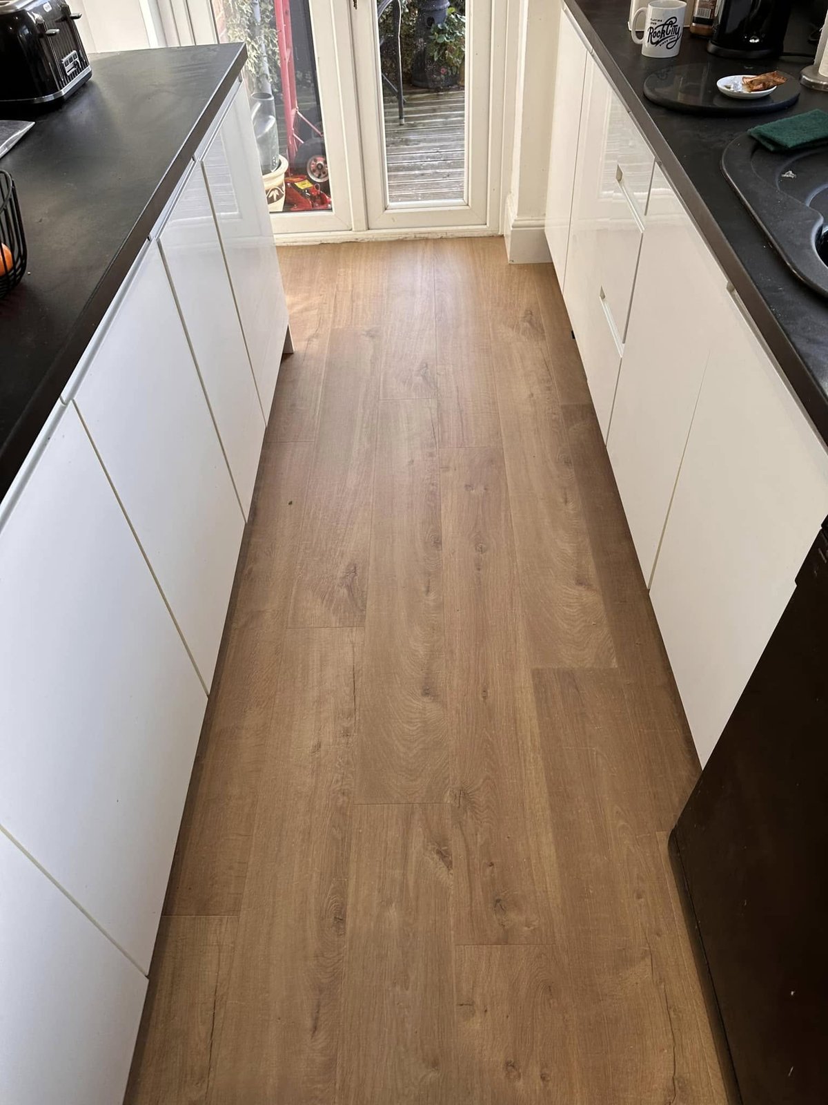 Kitchen renovation with new flooring and cabinets.