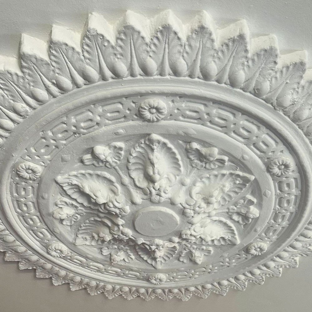 Close-up of a decorative plaster ceiling medallion.