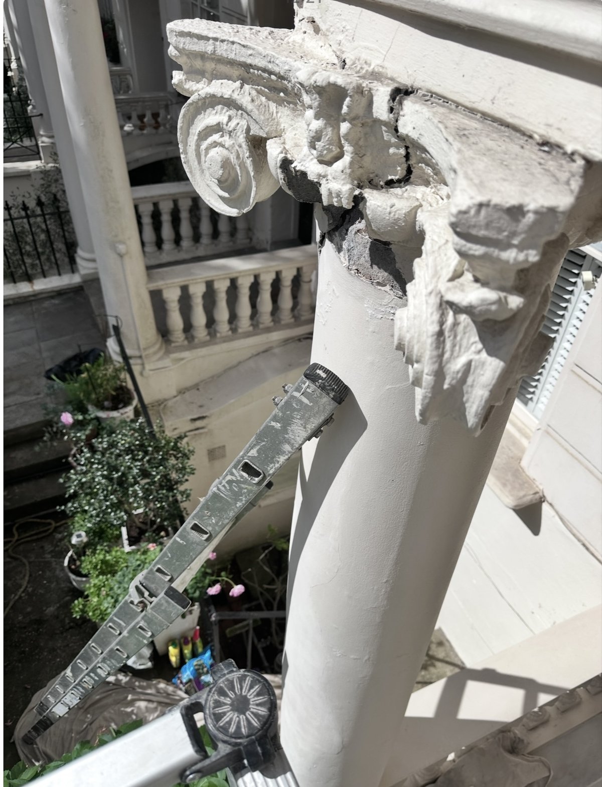 Close-up of plaster moulding column with ladder