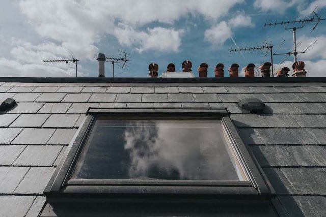 Slate roof with skylight, showcasing a combination of traditional and modern elements.