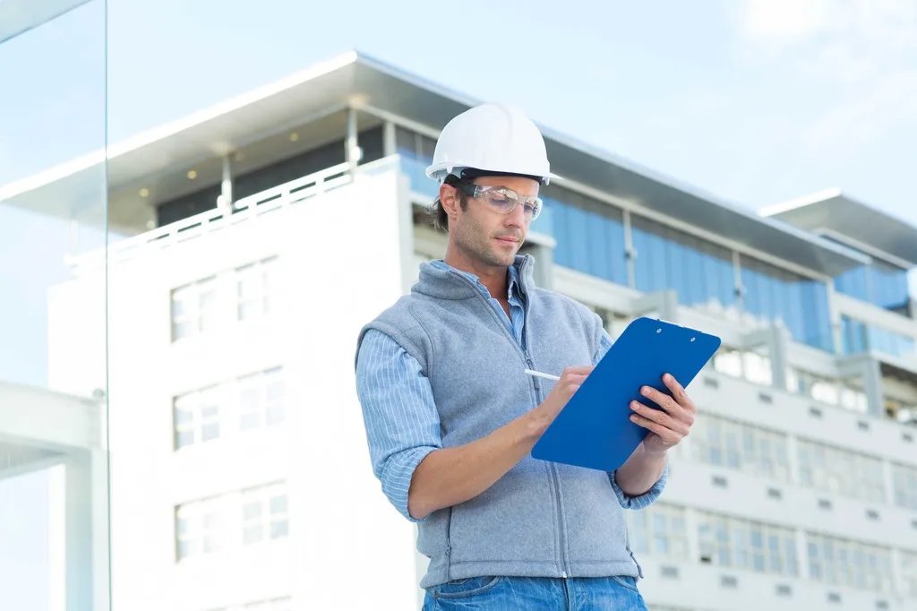 Surveyor with clipboard on site.