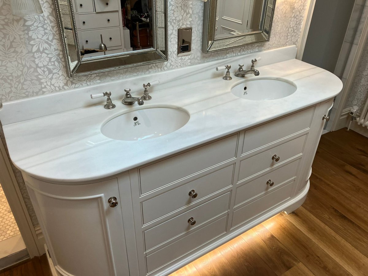 Bathroom with marble countertop and refinished wood floor