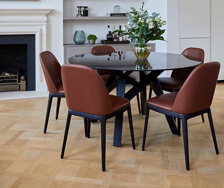 Dining room with wood flooring, showcasing the company's flooring work in a furnished period home setting.